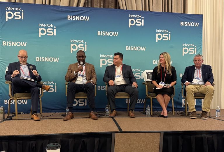 Five people seated on a panel stage with a "Bisnow" and "Intertek PSI" banner, engaged in a discussion.