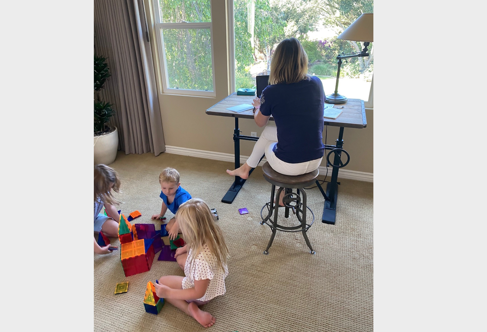 Lightbox Senior Vice President, Broker Operations Tina Lichens works from home while her children play in the room