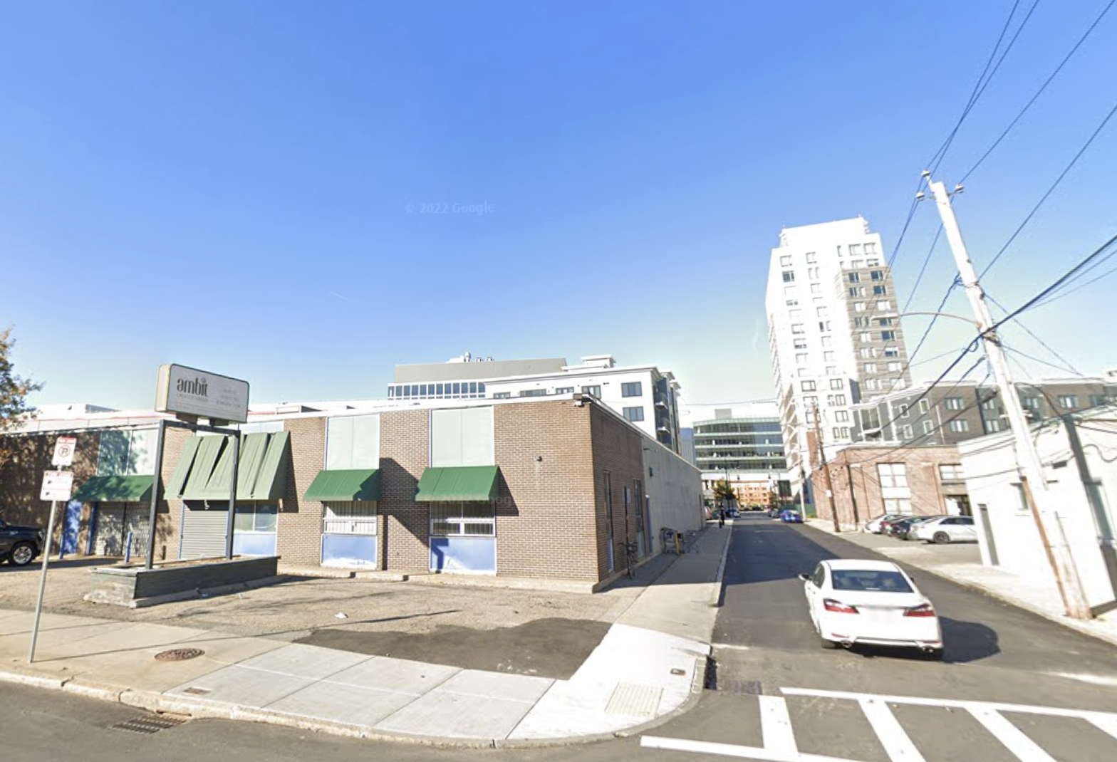 The one-story building at 131 North Beacon St. (left), where NB Development proposed a condo project, with its Boston Landing campus pictured in the background.  