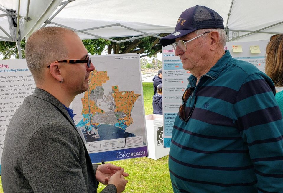 Long Beach Development Services Planning Bureau Manager Christopher Koontz (left) speaks to a concerned resident about climate change during the city of Long Beach climate fest.