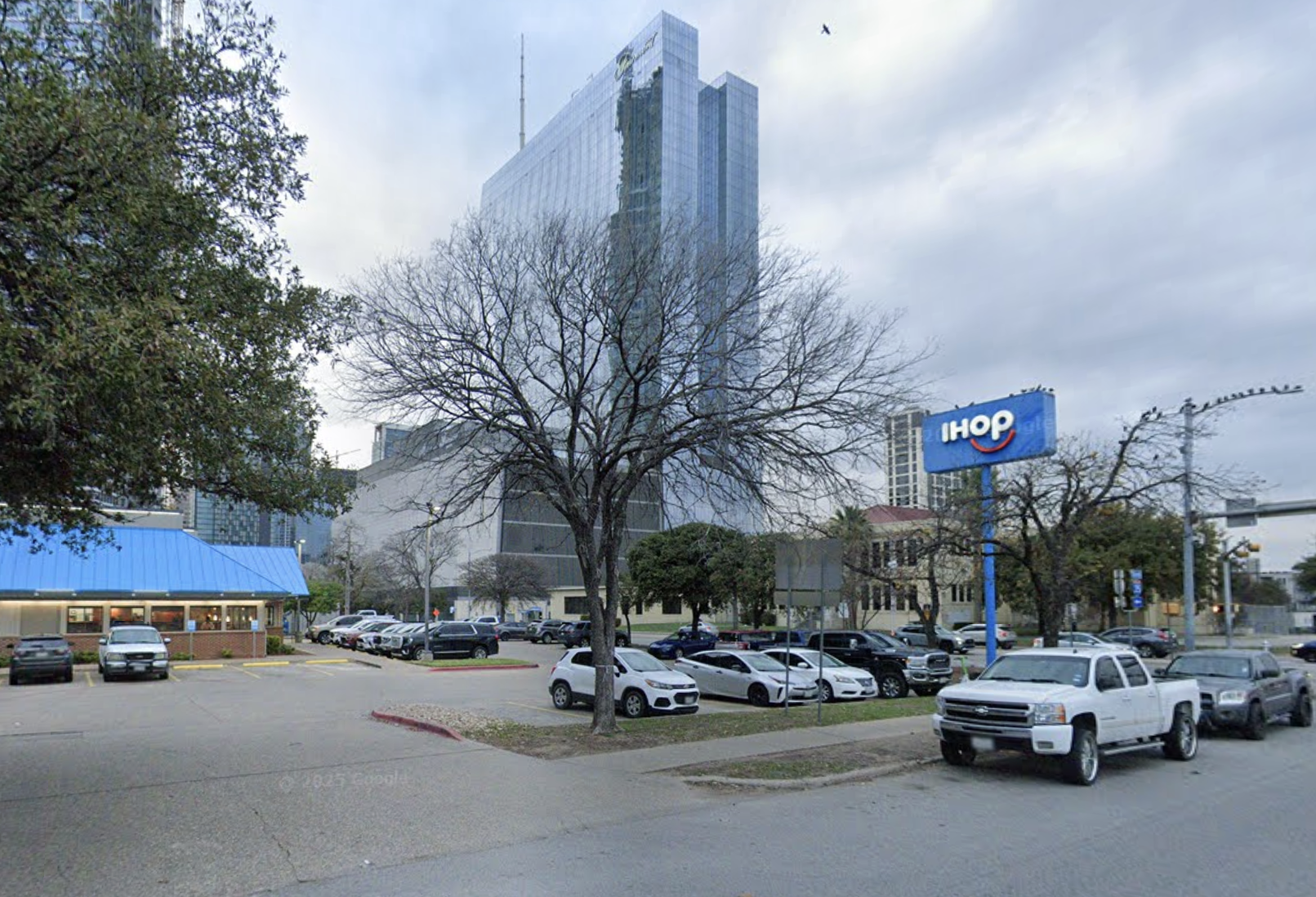An IHOP surrounded by a tall building