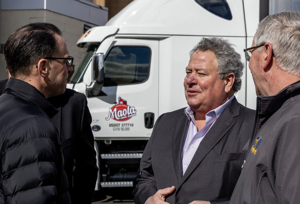 Pennsylvania Gov. Josh Shapiro in front of a Maola truck at the event for the purchase of HP's dairy plant in Philadelphia.