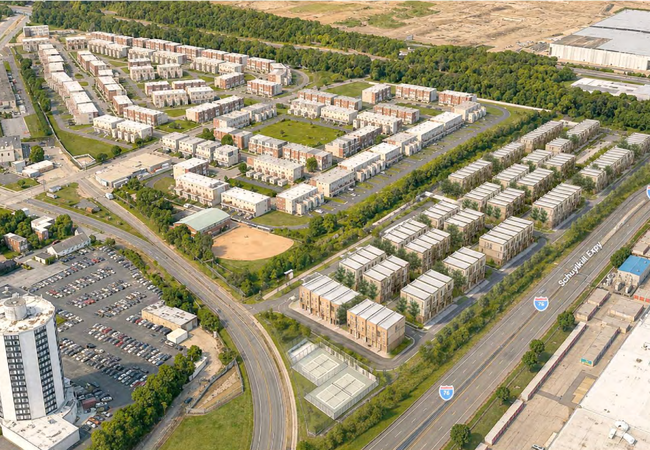 Aerial view of a suburban residential area with rows of apartment buildings, surrounding roads, a baseball field, and a nearby highway.