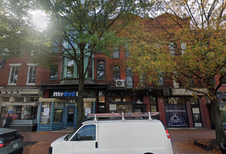 Row of three and four story converted townhomes with ground-floor retail and office space.
