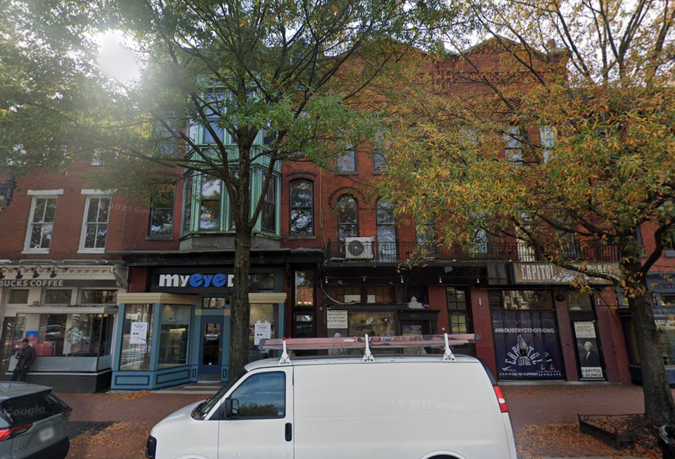 Row of three and four story converted townhomes with ground-floor retail and office space.