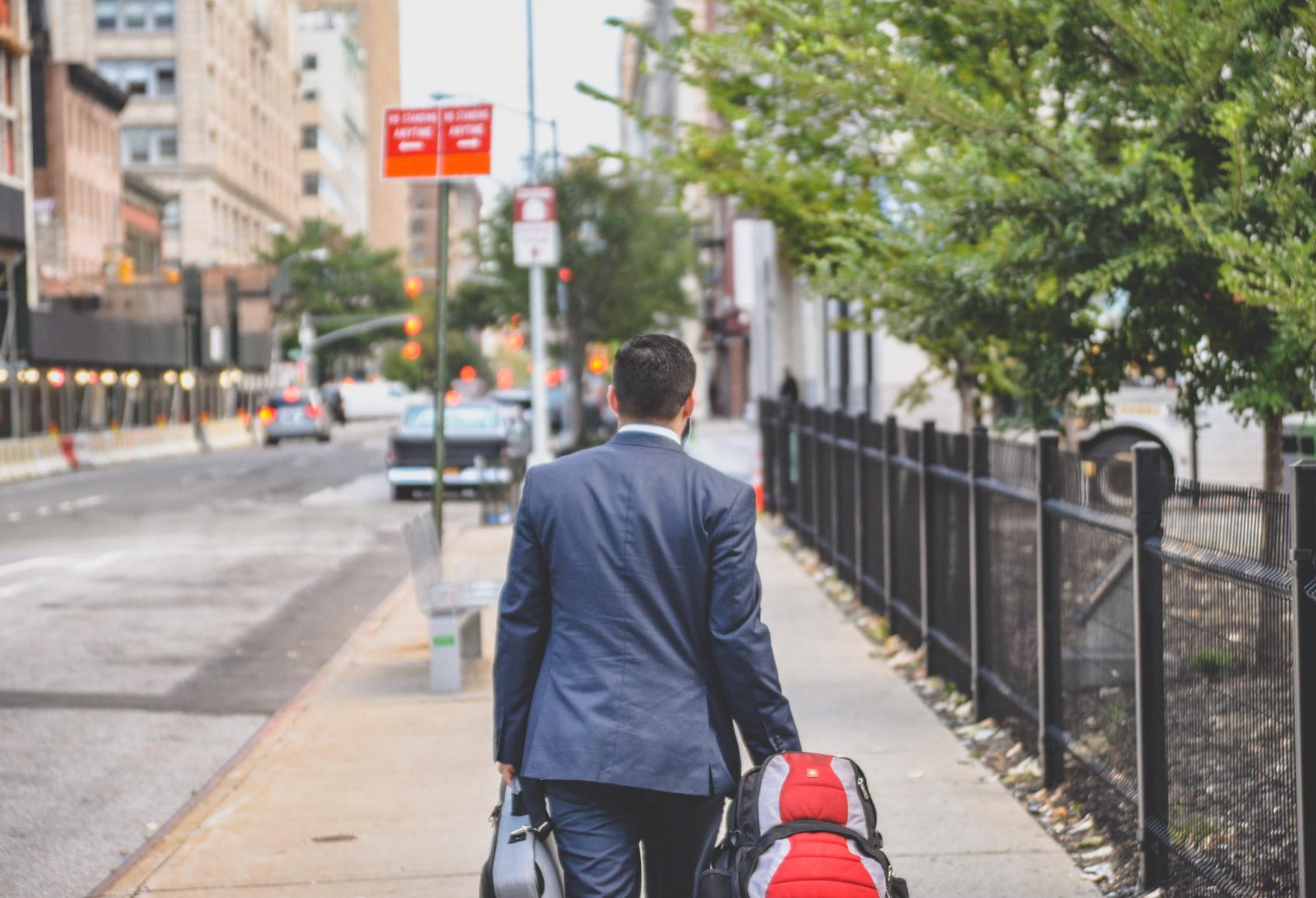 Man with backpack and briefcase