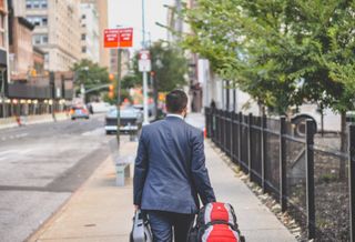 Man with backpack and briefcase