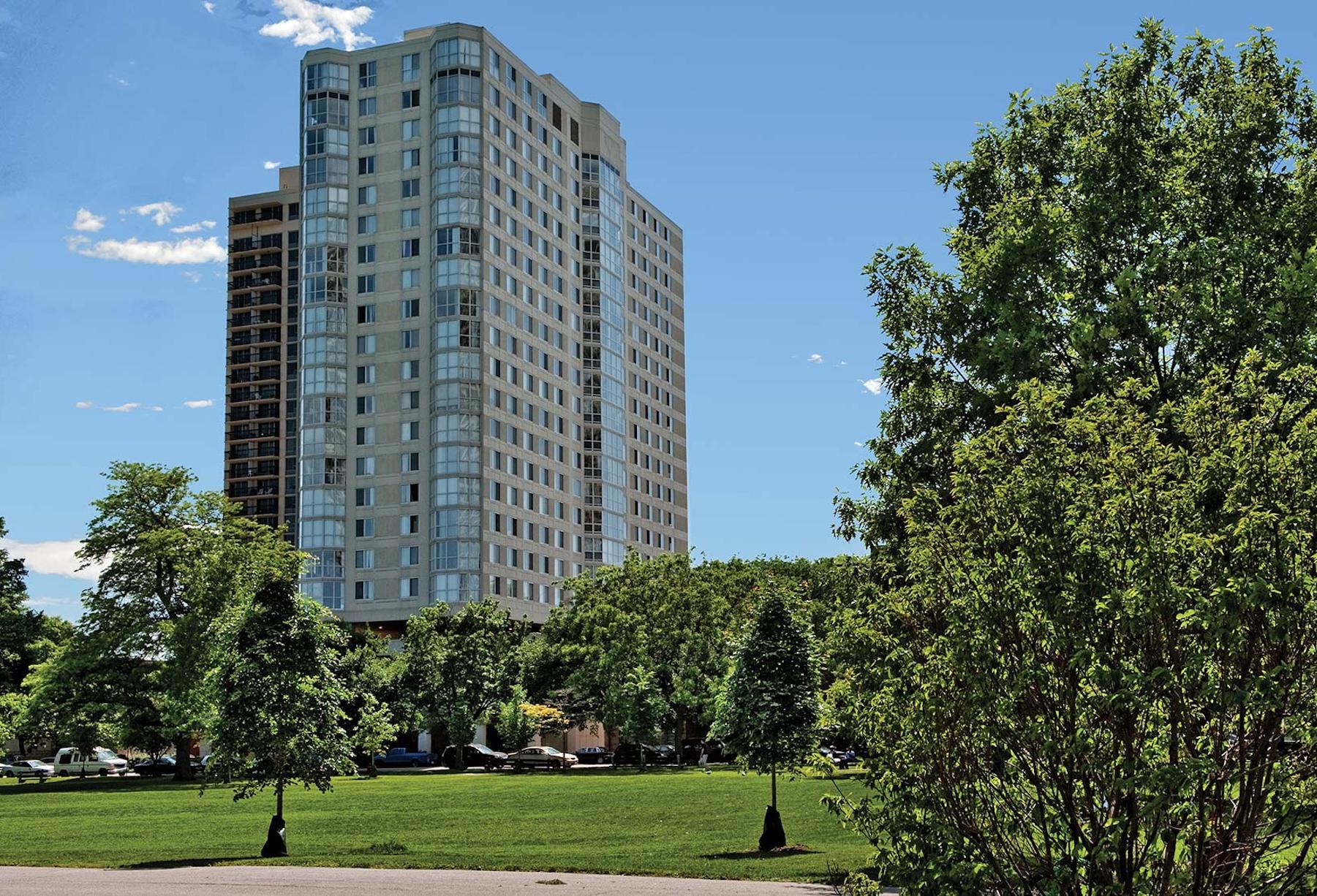 Hyde Park Tower in Chicago flanked by trees.