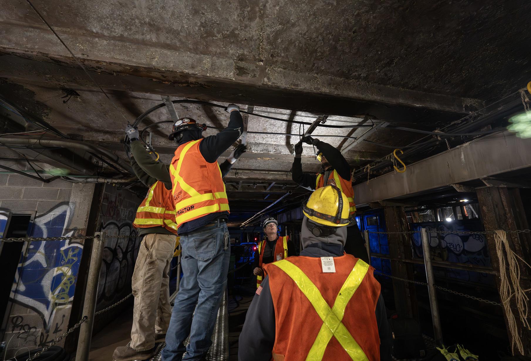 MTA employees working in a New York City subway tunnel.