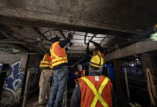 MTA employees working in a New York City subway tunnel.