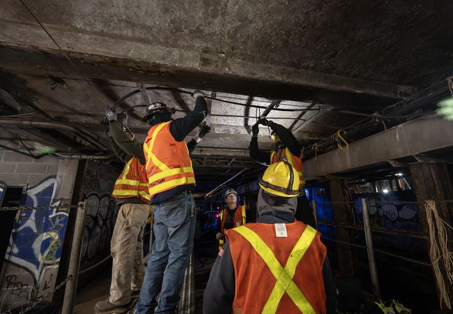 MTA employees working in a New York City subway tunnel.