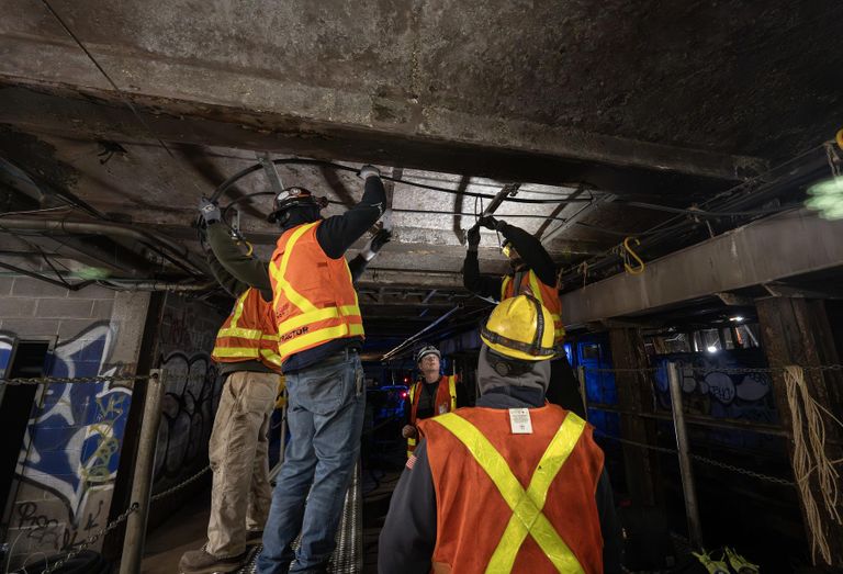 MTA employees working in a New York City subway tunnel.