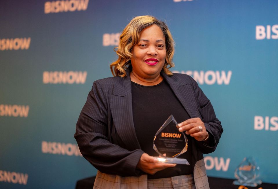 A woman holding an award