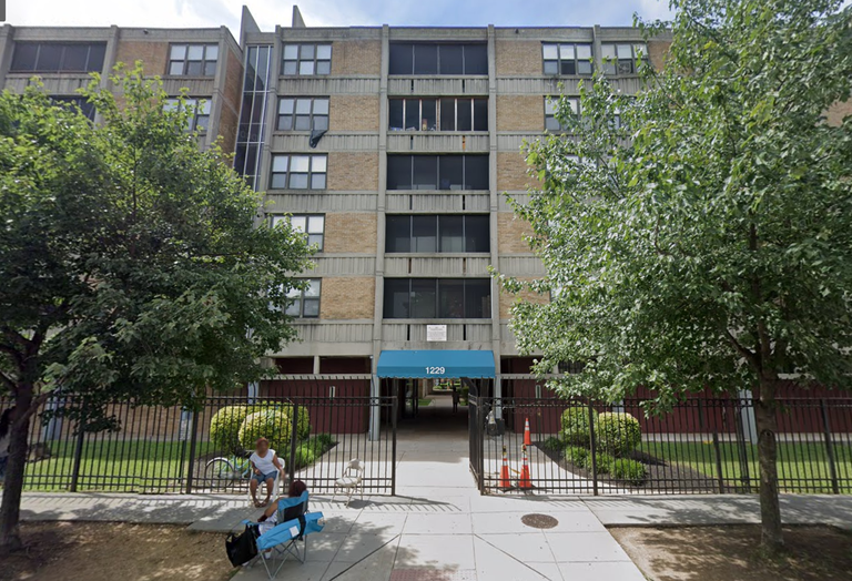 Exterior facade of the Potomac Gardens housing complex showing signs of maintenance issues