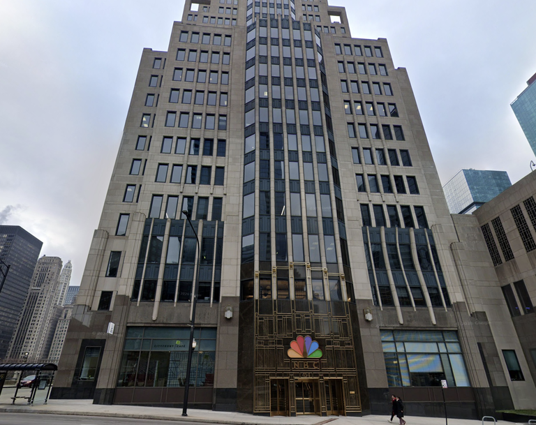 Tall Art Deco-style building with numerous windows, featuring the NBC logo above a grand entrance.