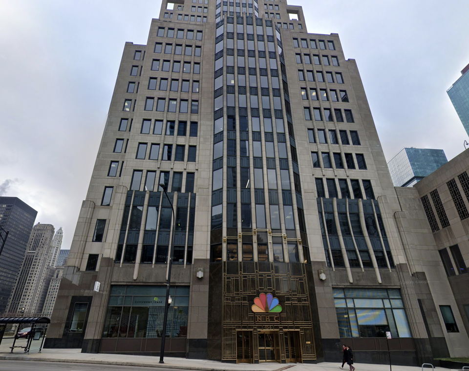 Tall Art Deco-style building with numerous windows, featuring the NBC logo above a grand entrance.