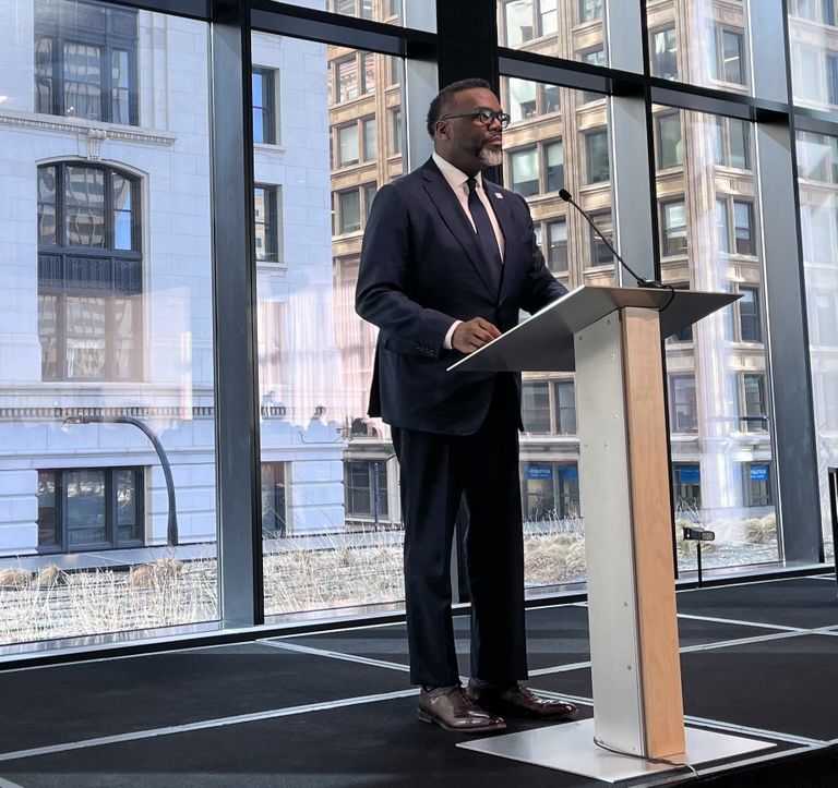 Chicago Mayor Brandon Johnson stands at a lectern.
