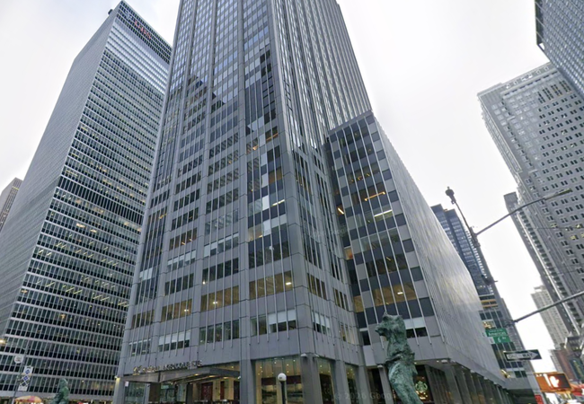 Tall modern office buildings in an urban area, with glass facades and surrounding street signs and statues.
