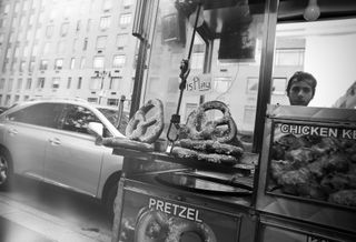 A street vendor selling pretzels