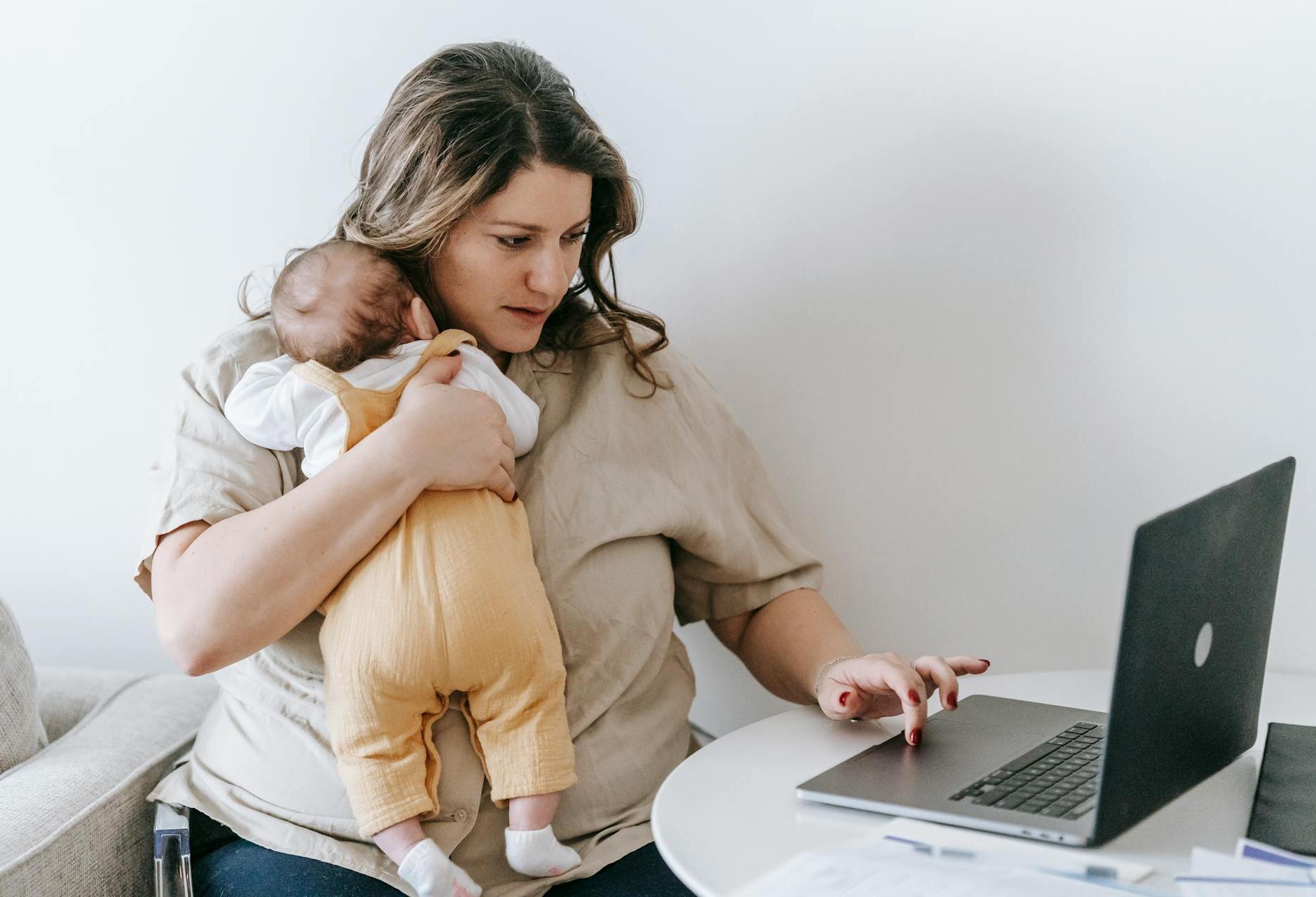 Working mother holding an infant