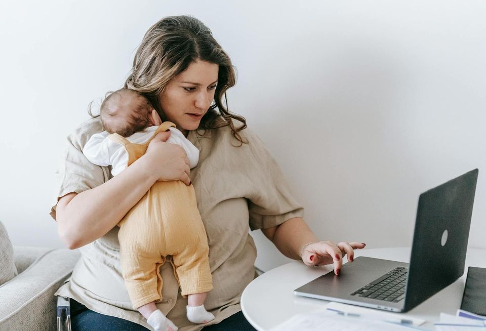 Working mother holding an infant