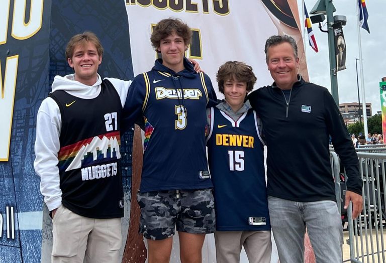 Tonaquint CEO Jim Buie and his sons at a Denver Nuggets game. 