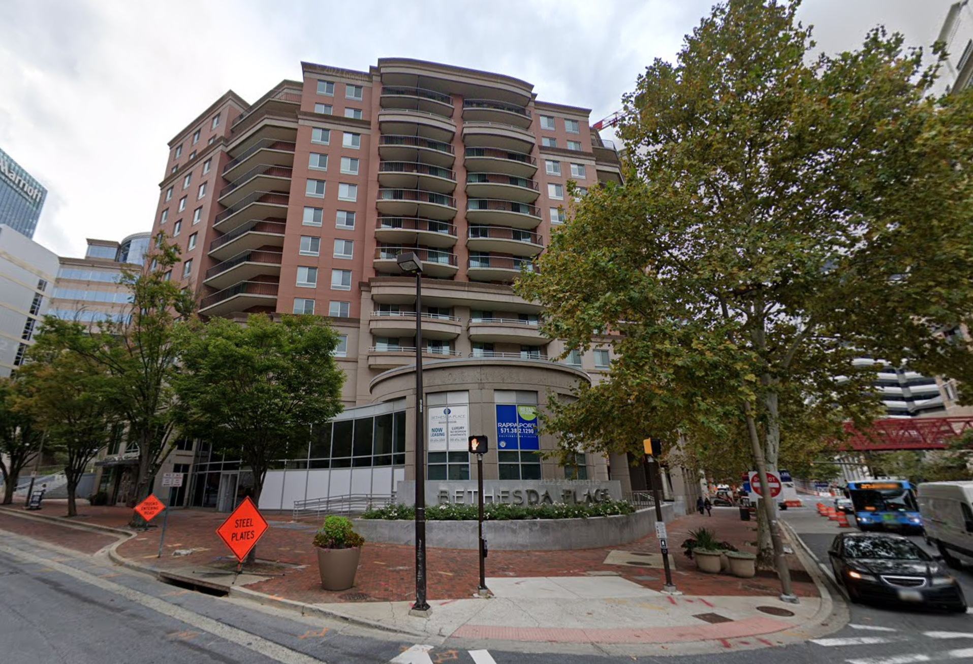 Multifamily property over retail with sign saying 
