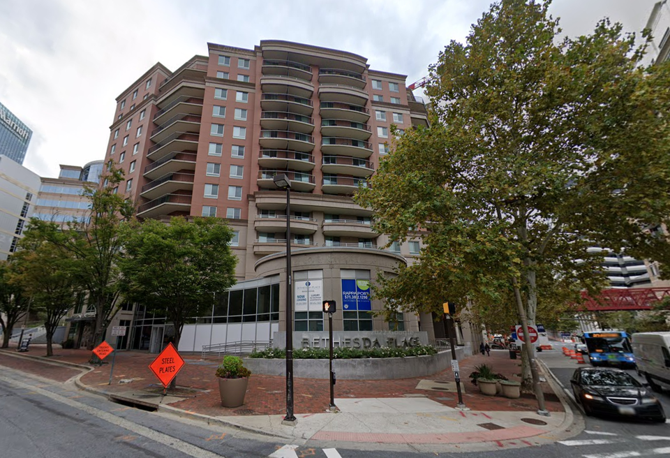 Multifamily property over retail with sign saying