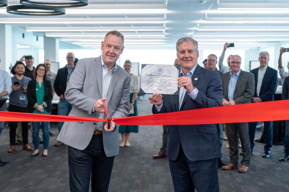 men cutting a ribbon
