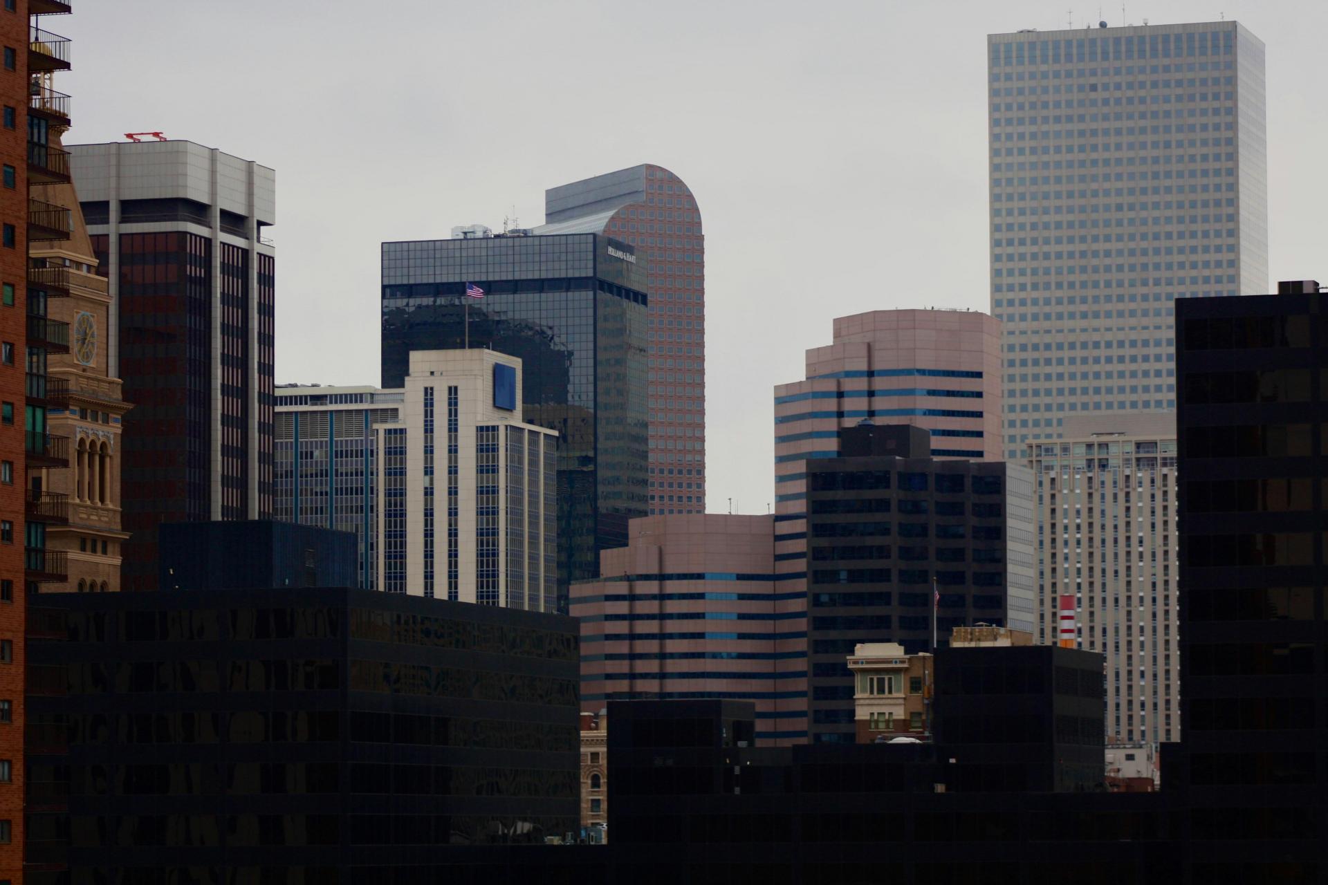 An image of the downtown Denver skyline on an overcast day with the cash-register building (Wells Fargo Center) at its center