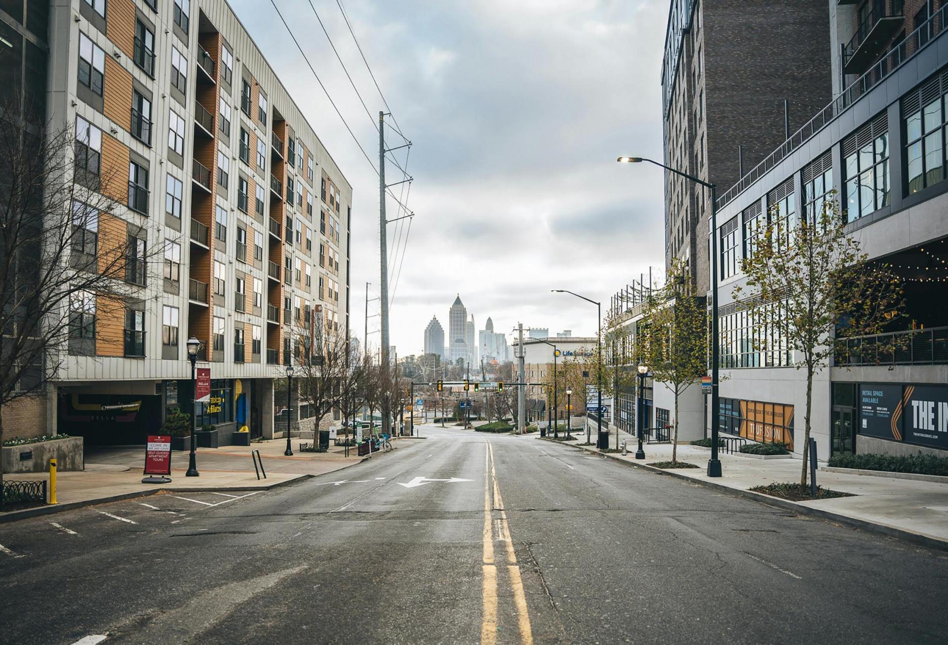 Photo by LaTisha Guster: https://www.pexels.com/photo/an-empty-road-between-city-buildings-10757123/