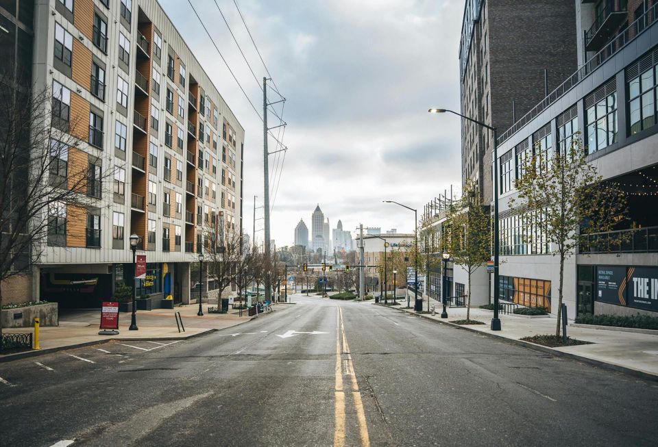 Photo by LaTisha Guster: https://www.pexels.com/photo/an-empty-road-between-city-buildings-10757123/