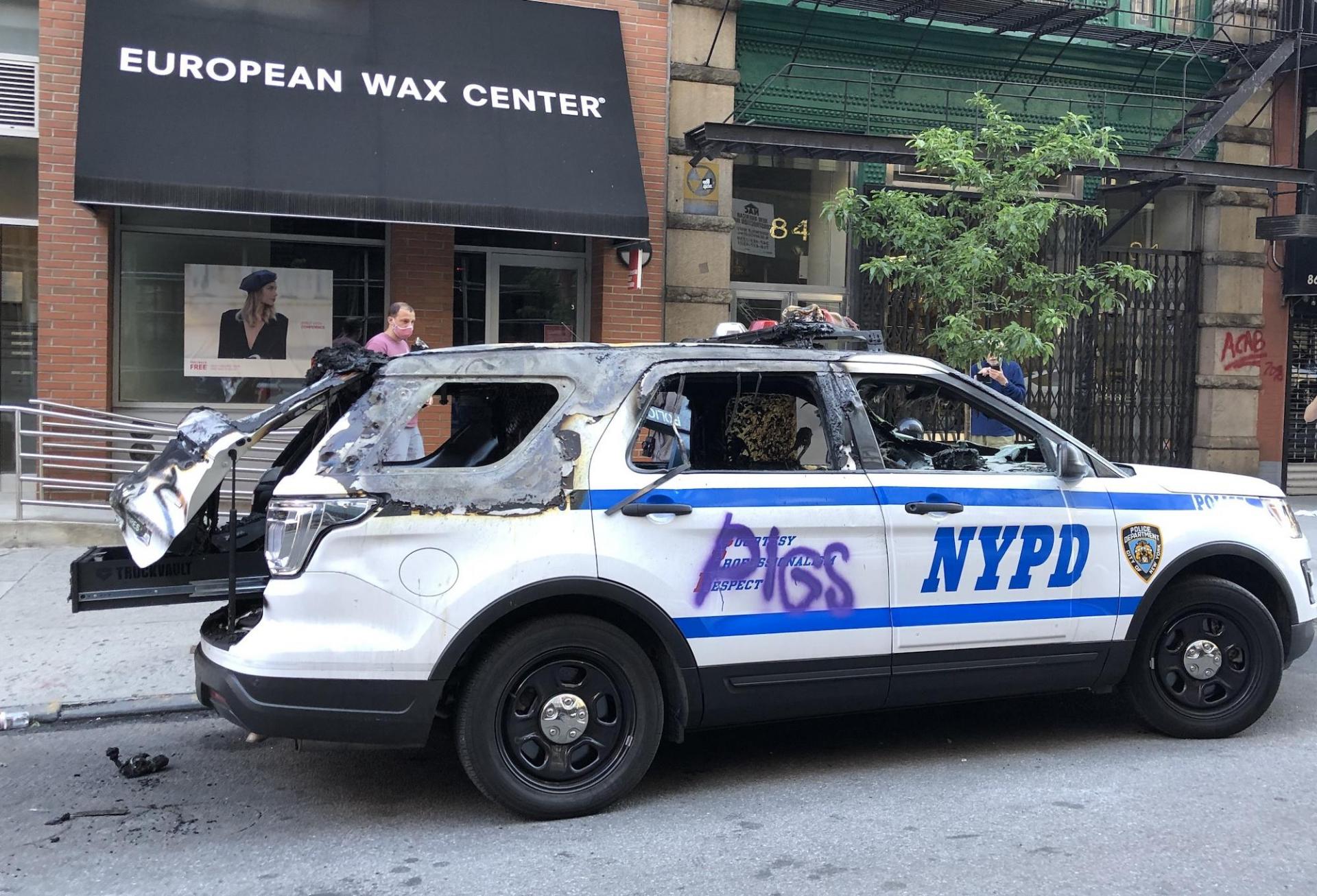 Police cars were among the chief targets of looters and vandals as demonstrations turned violent.