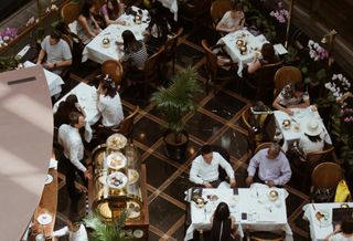People sitting in a busy restaurant.