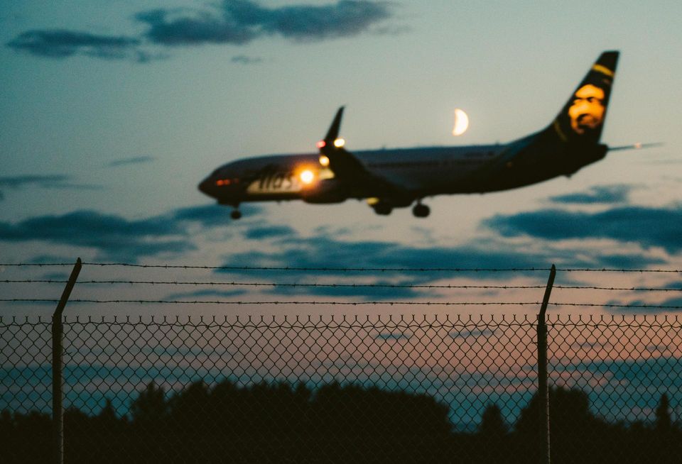 Ominous plane with a fence at night
