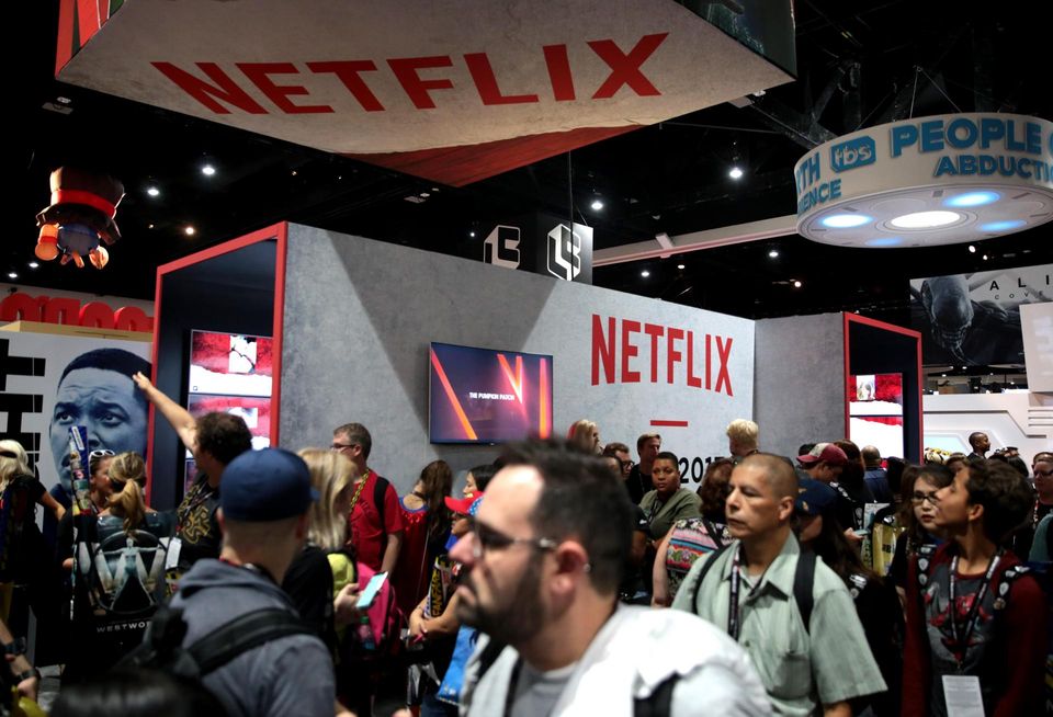 Attendees walk through a Netflix Booth