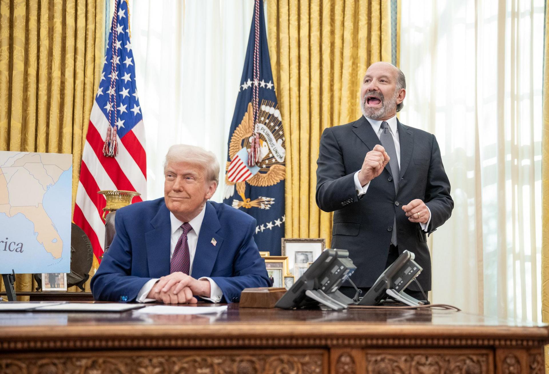 Newmark Chairman Howard Lutnick, nominee for Secretary of Commerce, speaks at the Oval Office next to President Donald Trump.