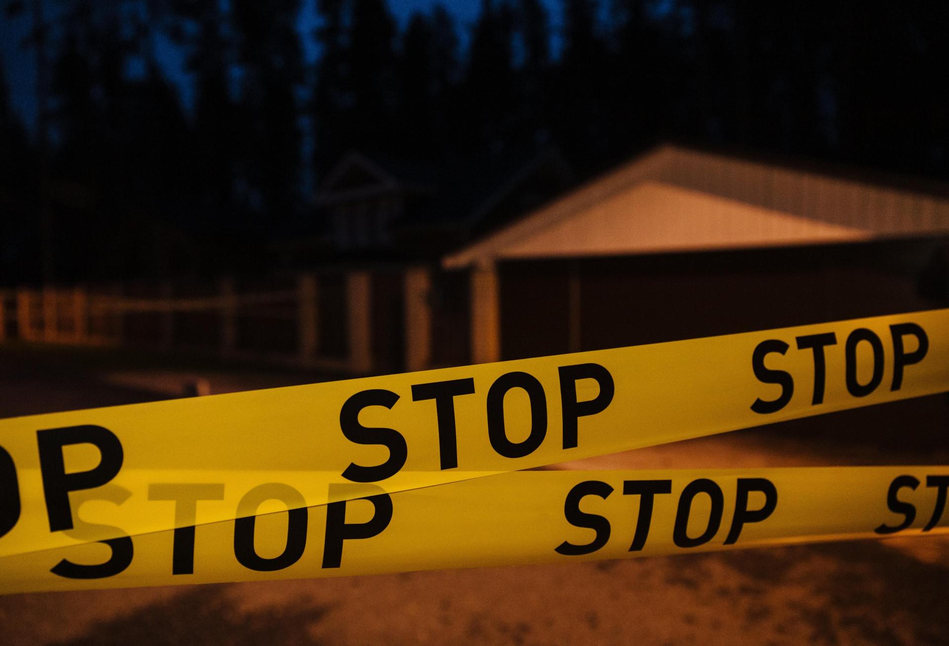 Crime scene tape with 'stop' printed on it