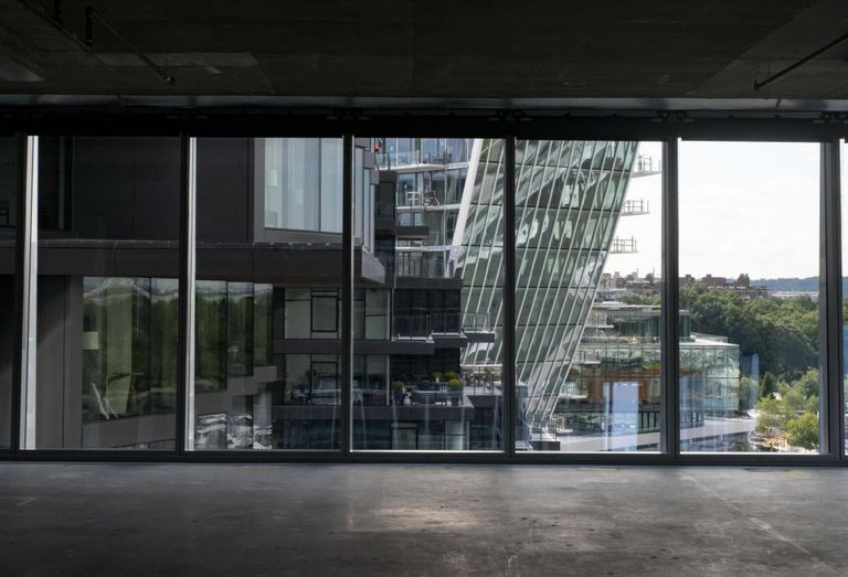 View looking out of raw office space toward The Pendry hotel, The Tides apartment building, and Amaris Condominium building.