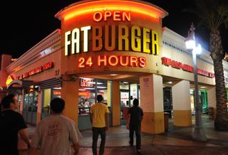 People walking into Fatburger.