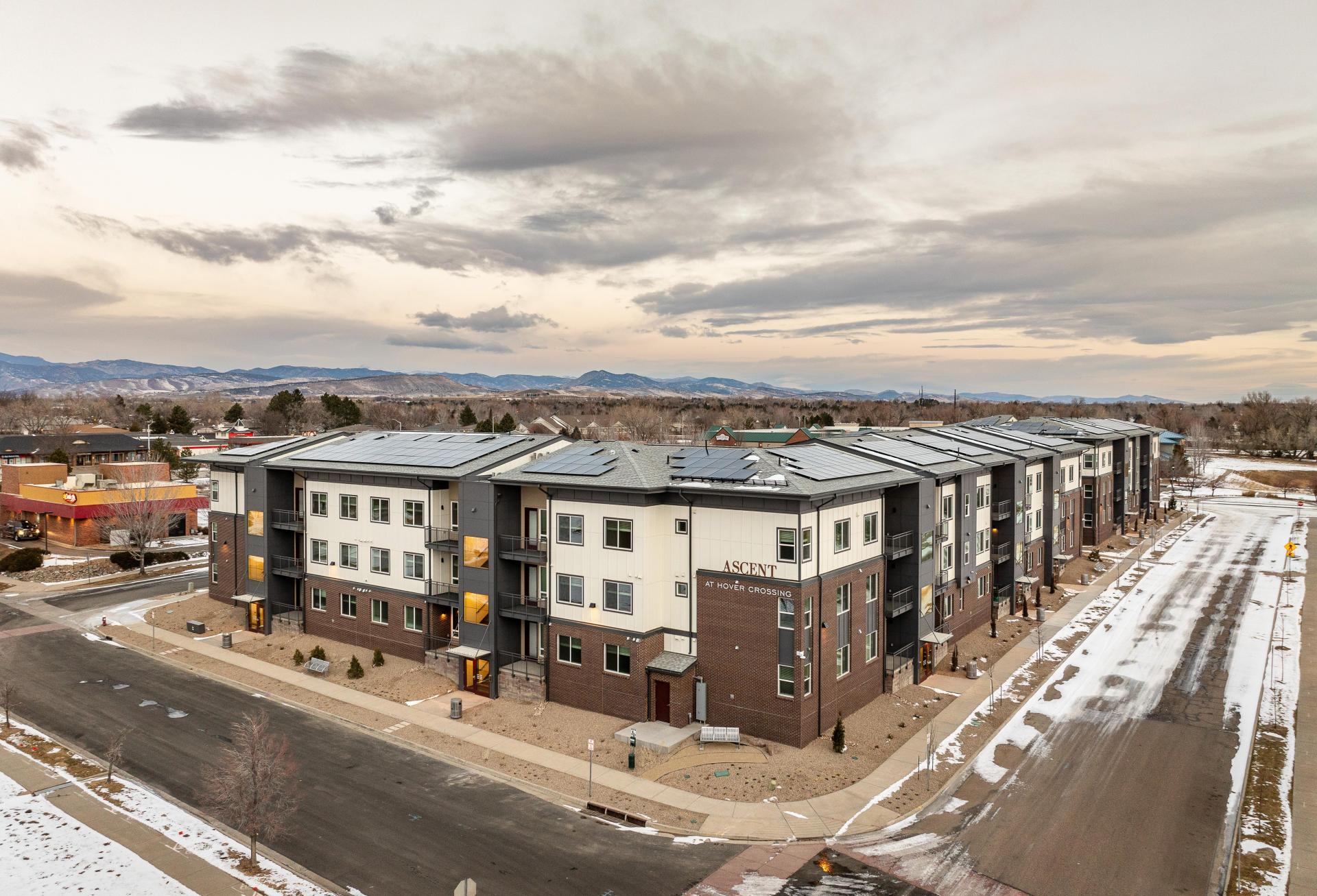 An aerial of the Ascent at Hover Crossing apartments with the mountains in the background
