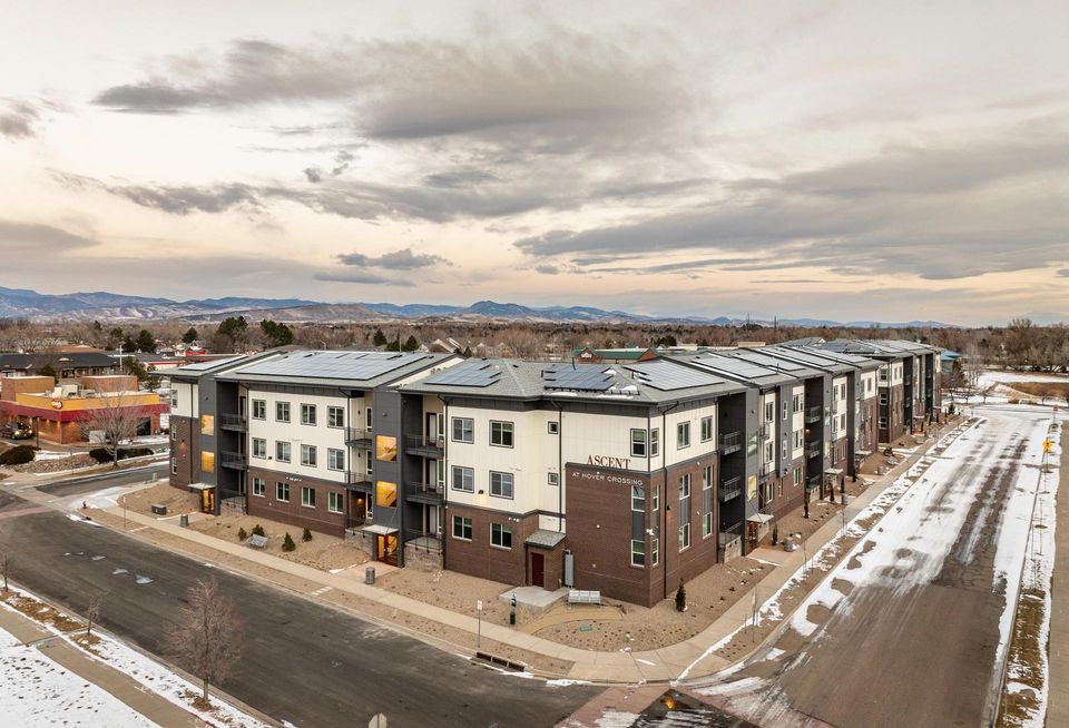 An aerial of the Ascent at Hover Crossing apartments with the mountains in the background