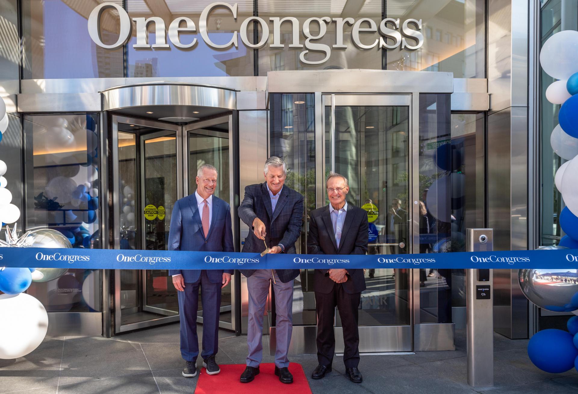 HYM Investment Group's Tom O'Brien, Carr Properties' Oliver Carr and National Real Estate Advisors' Jeff Kanne at the ribbon cutting to officially open the One Congress office building.
