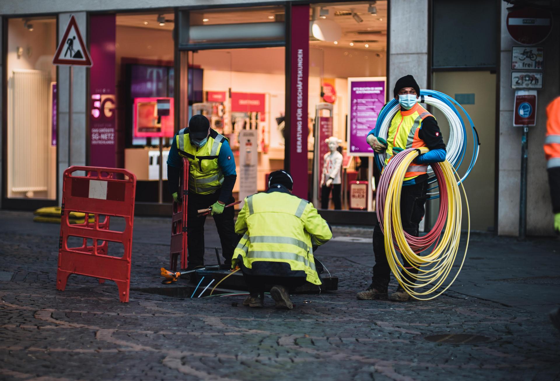 Technicians installing empty pipes for fast fiber internet.