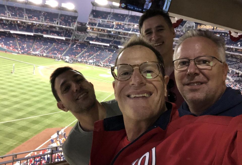 CohnReznick Managing Partner David Kessler poses with CohnReznick's Adam Goodman and MTAG Services' Adam Berman and Jim Meeks at the World Series.