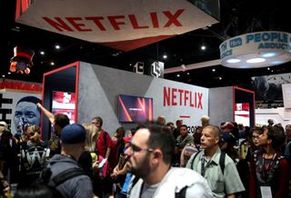 Attendees walk through a Netflix Booth
