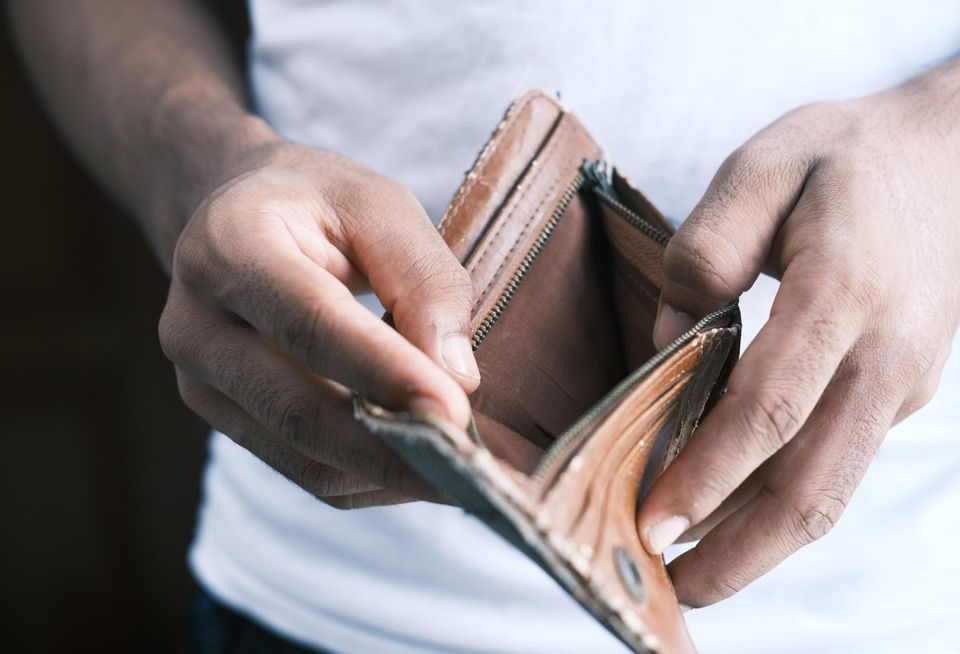 A man holding an empty wallet 