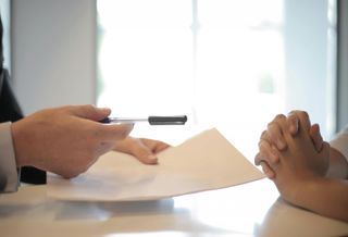 Photo of someone signing a contract