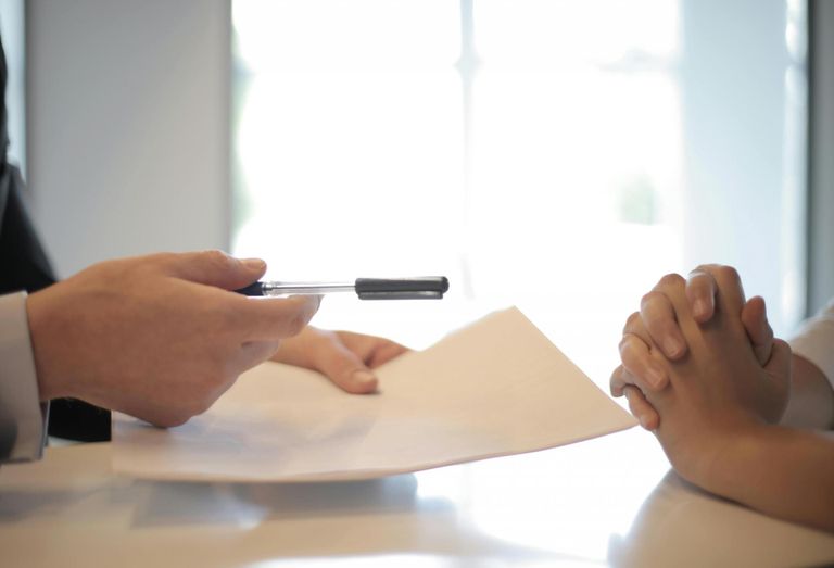 Photo of someone signing a contract