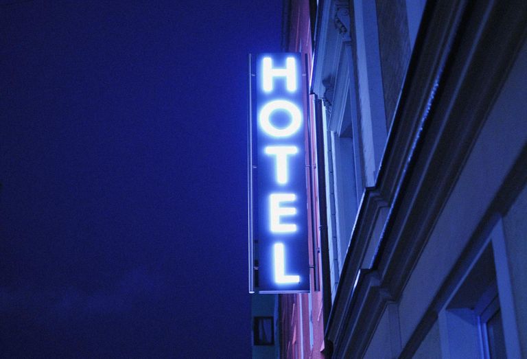 Blue neon light hotel sign.